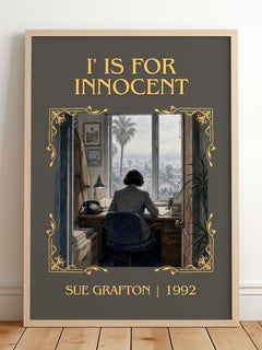 I' Is for Innocent Classic Book Art Print by Sue Grafton – framed print leaning on a wooden floor