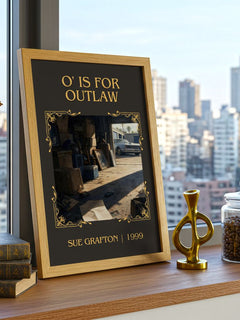 O' Is for Outlaw Classic Book Art Print by Sue Grafton – framed print on a city-view windowsill