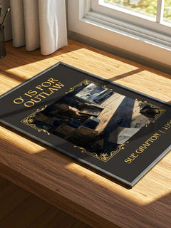 O' Is for Outlaw Classic Book Art Print by Sue Grafton – print on a sunlit desk