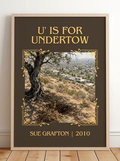 U' Is for Undertow Classic Book Art Print by Sue Grafton – framed print leaning on a wooden floor