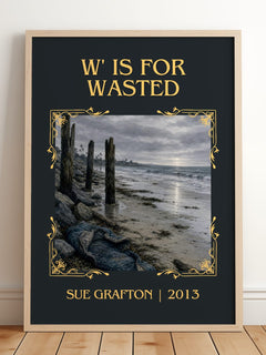 W' Is for Wasted Classic Book Art Print by Sue Grafton – framed print leaning on a wooden floor
