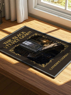 The Black Velvet Gown Classic Book Art Print by Catherine Cookson – print on a sunlit desk