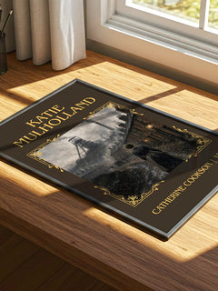Katie Mulholland Classic Book Art Print by Catherine Cookson – print on a sunlit desk