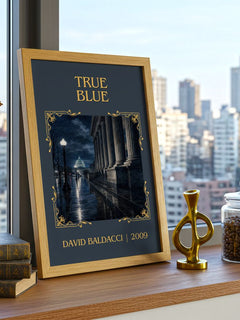 True Blue Classic Book Art Print by David Baldacci – framed print on a city-view windowsill