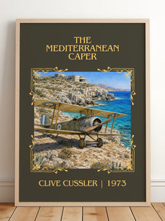 The Mediterranean Caper Classic Book Art Print by Clive Cussler – framed print leaning on a wooden floor