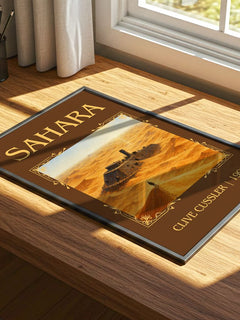 Sahara Classic Book Art Print by Clive Cussler – print on a sunlit desk