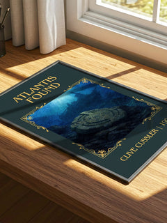 Atlantis Found Classic Book Art Print by Clive Cussler – print on a sunlit desk