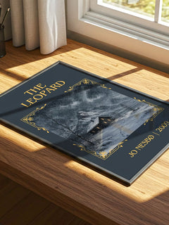 The Leopard Classic Book Art Print by Jo Nesbø – print on a sunlit desk