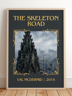 The Skeleton Road Classic Book Art Print by Val McDermid – framed print leaning on a wooden floor