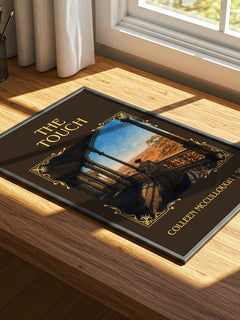 The Touch Classic Book Art Print by Colleen McCullough – print on a sunlit desk