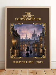 The Secret Commonwealth Classic Book Art Print by Philip Pullman – framed print leaning on a wooden floor