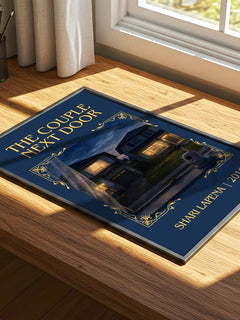 The Couple Next Door Classic Book Art Print by Shari Lapena – print on a sunlit desk