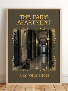 The Paris Apartment Classic Book Art Print by Lucy Foley – framed print leaning on a wooden floor