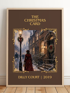 The Christmas Card Classic Book Art Print by Dilly Court – framed print leaning on a wooden floor