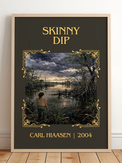 Skinny Dip Classic Book Art Print by Carl Hiaasen – framed print leaning on a wooden floor