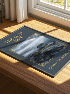 The Lost Boy Classic Book Art Print by Camilla Läckberg – print on a sunlit desk
