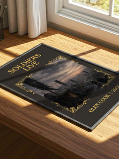 Soldiers Live Classic Book Art Print by Glen Cook – print on a sunlit desk