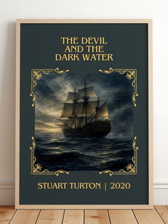 The Devil and the Dark Water Classic Book Art Print by Stuart Turton – framed print leaning on a wooden floor