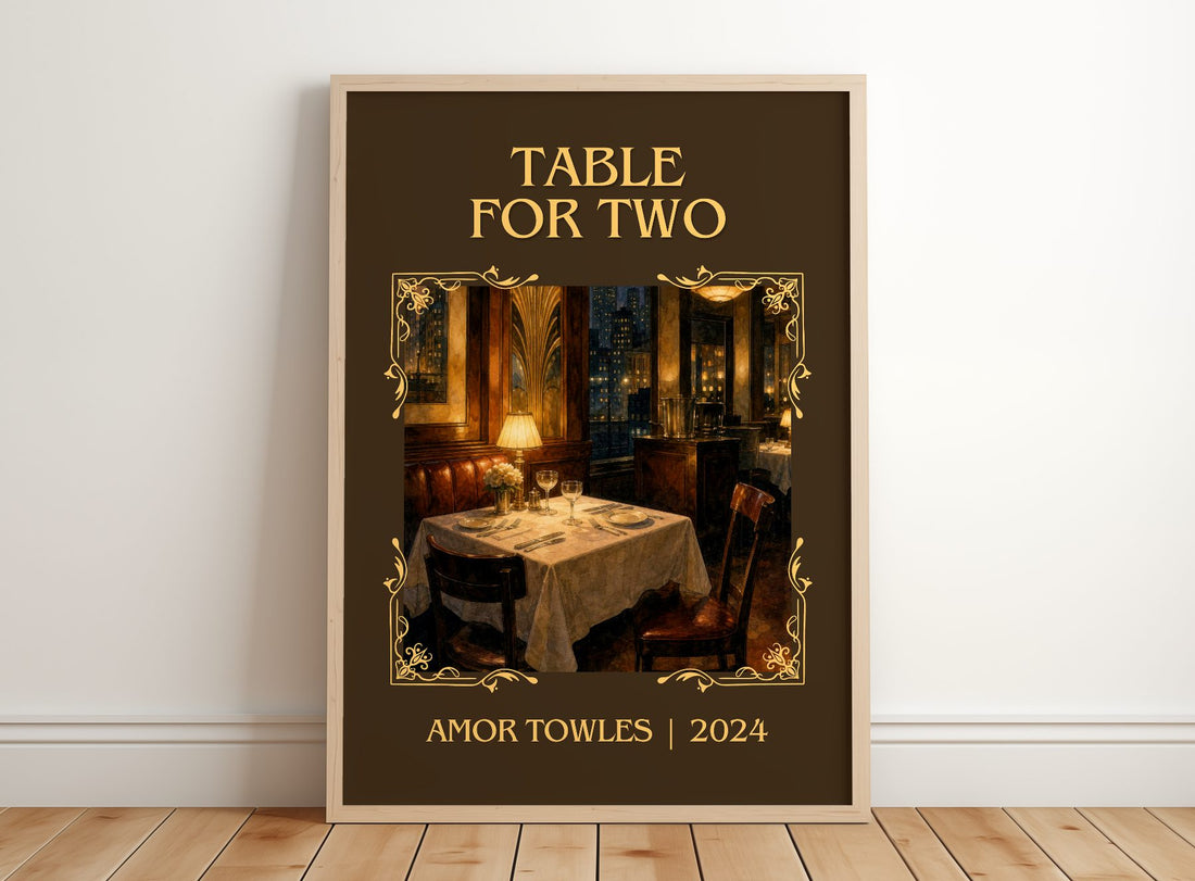 Table for Two Classic Book Art Print by Amor Towles – framed print leaning on a wooden floor
