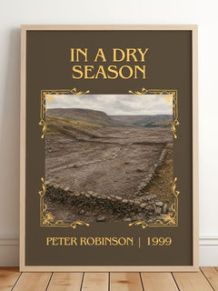 In a Dry Season Classic Book Art Print by Peter Robinson – framed print leaning on a wooden floor