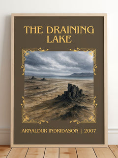 The Draining Lake Classic Book Art Print by Arnaldur Indriðason – framed print leaning on a wooden floor