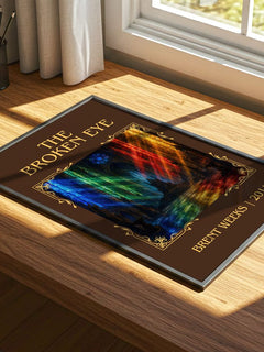 The Broken Eye Classic Book Art Print by Brent Weeks – print on a sunlit desk