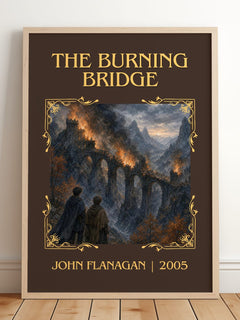 The Burning Bridge Classic Book Art Print by John Flanagan – framed print leaning on a wooden floor