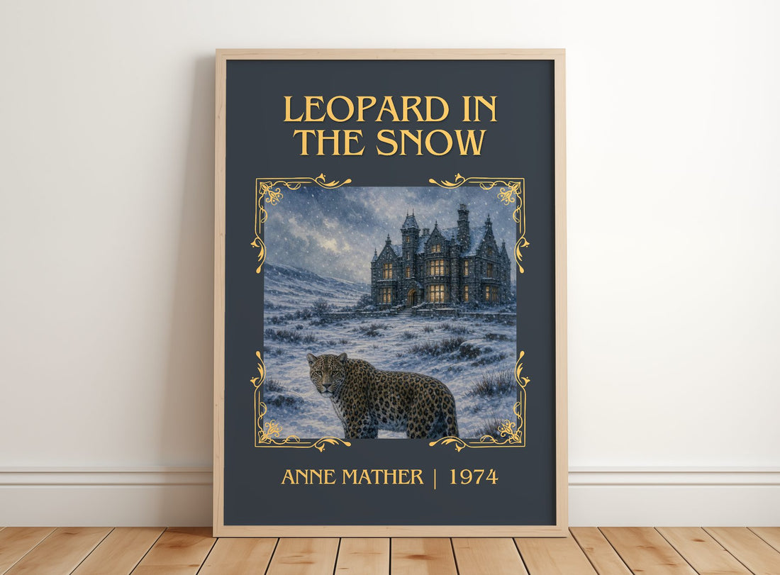 Leopard in the Snow Classic Book Art Print by Anne Mather – framed print leaning on a wooden floor