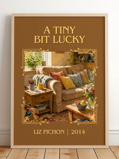 A Tiny Bit Lucky Classic Book Art Print by Liz Pichon – framed print leaning on a wooden floor