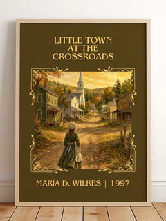 Little Town at the Crossroads Classic Book Art Print by M. Wilkes – framed print leaning on a wooden floor