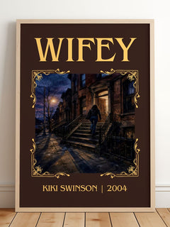 Wifey Classic Book Art Print by Kiki Swinson – framed print leaning on a wooden floor
