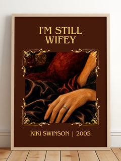 I'm Still Wifey Classic Book Art Print by Kiki Swinson – framed print leaning on a wooden floor