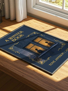 A winter book Classic Book Art Print by Tove Jansson – print on a sunlit desk