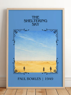 The Sheltering Sky Classic Book Art Print by Paul Bowles – framed print leaning on a wooden floor