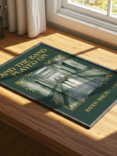 And the Band Played On Classic Book Art Print by Randy Shilts – print on a sunlit desk