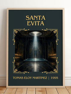Santa Evita Classic Book Art Print by Tomás Eloy Martínez – framed print leaning on a wooden floor