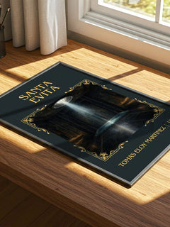 Santa Evita Classic Book Art Print by Tomás Eloy Martínez – print on a sunlit desk