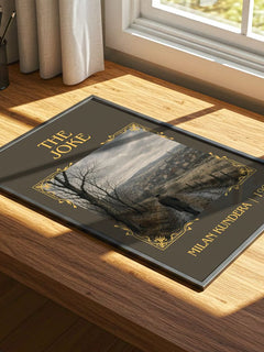 The Joke Classic Book Art Print by Milan Kundera – print on a sunlit desk