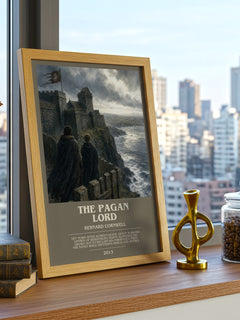 The Pagan Lord Bookish Wall Art by Bernard Cornwell – framed print on a city-view windowsill