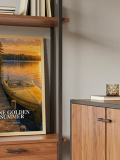 One Golden Summer Book Watercolour Illustration by Carley Fortune – framed print on a shelf by a wooden cabinet