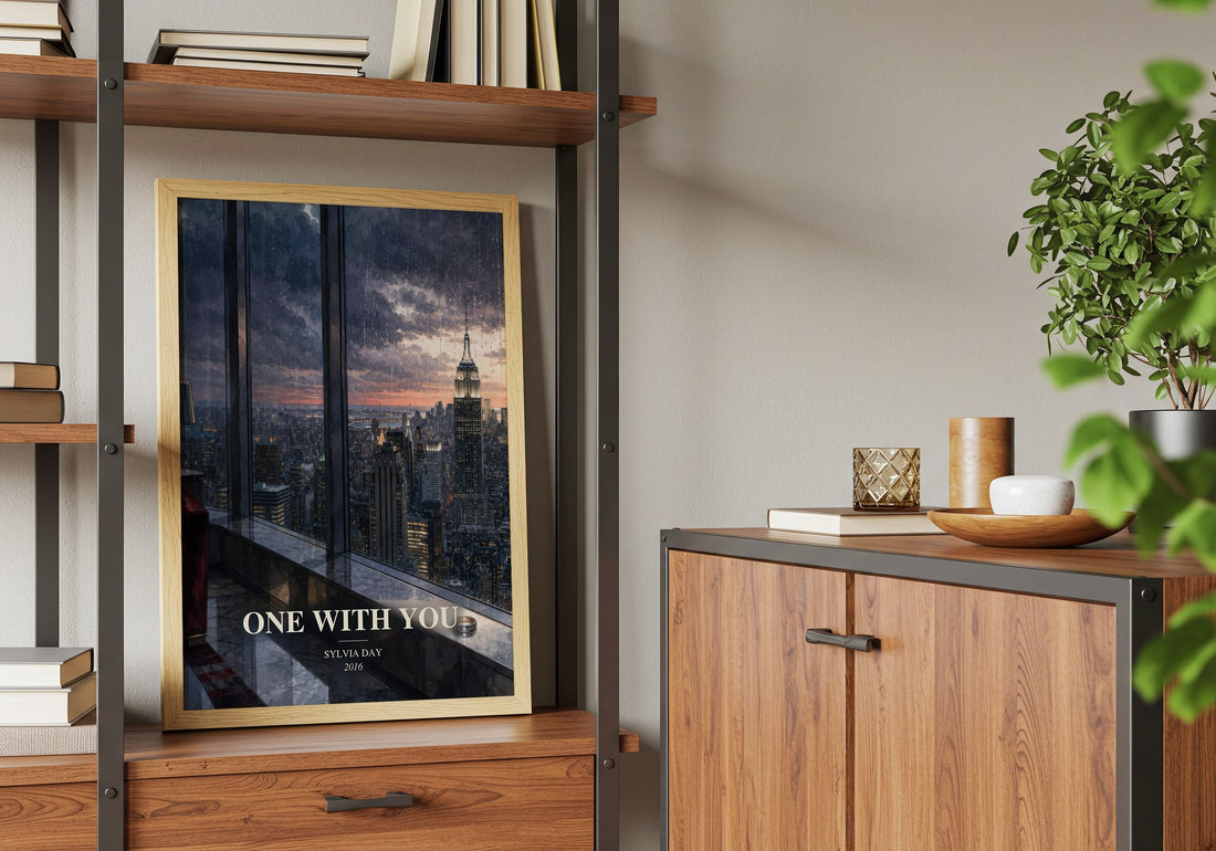 One with You Book Watercolour Illustration by Sylvia Day – framed print on a shelf by a wooden cabinet