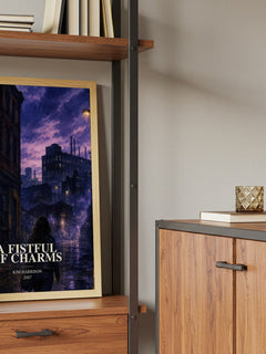 A Fistful of Charms Book Watercolour Illustration by Kim Harrison – framed print on a shelf by a wooden cabinet