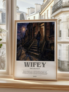 Wifey Bookish Wall Art by Kiki Swinson – framed print by a bright window