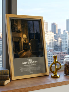 The Adversary Bookish Wall Art by Emmanuel Carrère – framed print on a city-view windowsill