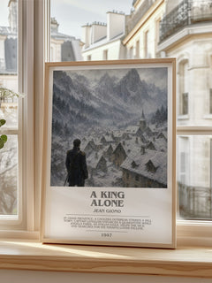 A King Alone Bookish Wall Art by Jean Giono – framed print by a bright window