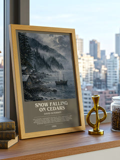 Snow Falling on Cedars Bookish Wall Art by David Guterson – framed print on a city-view windowsill