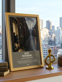 Say Nothing Bookish Wall Art by Patrick Radden Keefe – framed print on a city-view windowsill
