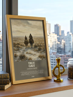 True Grit Bookish Wall Art by Charles Portis – framed print on a city-view windowsill