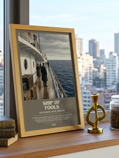 Ship Of Fools Bookish Wall Art by Katherine Anne Porter – framed print on a city-view windowsill