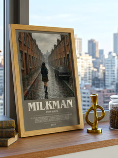 Milkman Bookish Wall Art by Anna Burns – framed print on a city-view windowsill